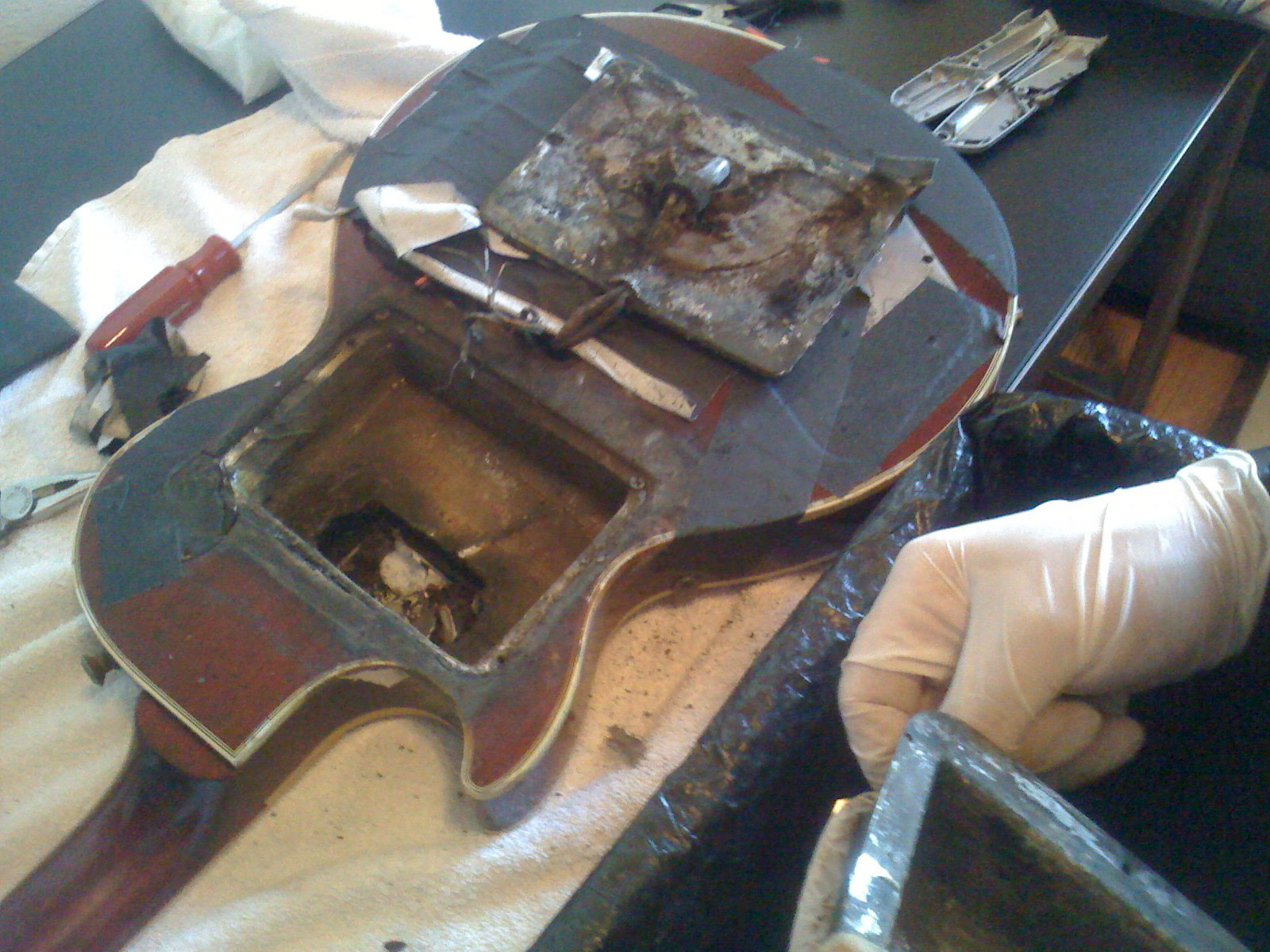 Rocco cleaning the back of the 'Smoke Bomb' guitar.
