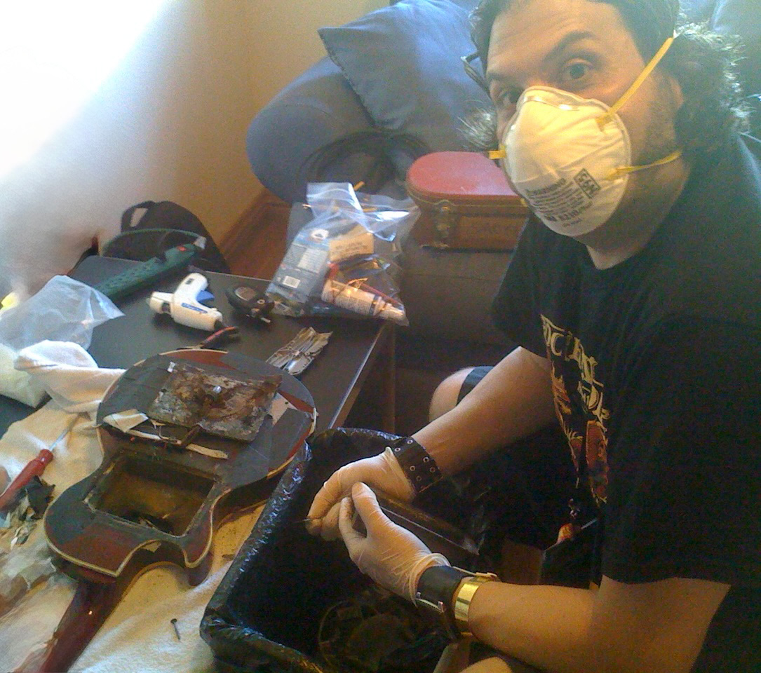 Rocco cleaning and preparing the 'Smoke Bomb' guitar for the next show.